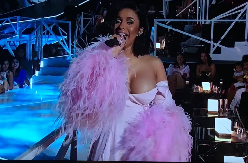 Cardi B's boobs nearly spill out of her strapless bra as she