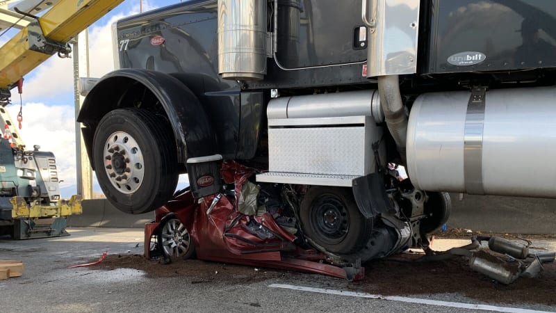 Hard to imagine how, but woman survives truck crushing her car€