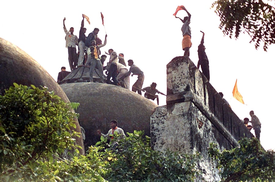 Hindu youths clamour atop the 16th century Babri Mosque on 6 December 1992. 