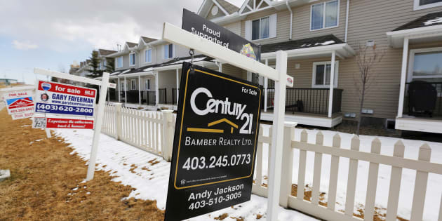 For sale signs line along a road where houses are for sale in Calgary, Alberta, April 7, 2015.