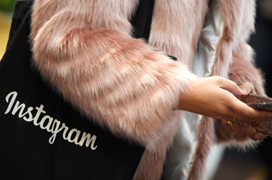 a woman carries an instagram branded bag at facebook s headquarters in london britain december - my week without instagram huffpost