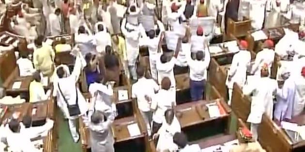 Image result for Bedlam in UP Assembly, paper balls thrown at Governor
