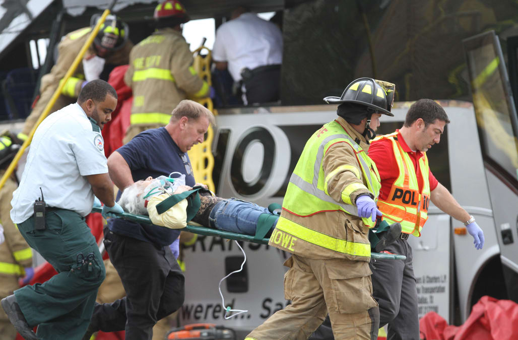 4 killed when freight train hits bus in Mississippi