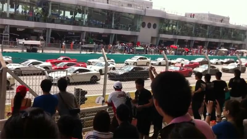 Porsche Cayman causes three-car pileup in parade of exotics