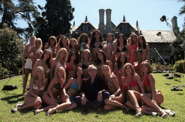 Publisher Hugh Hefner poses with a few of the 100 girls vying to be the 50th Anniversary Playmateon April 8, 2003 at the Playboy Mansion, Beverly Hills, Calif.