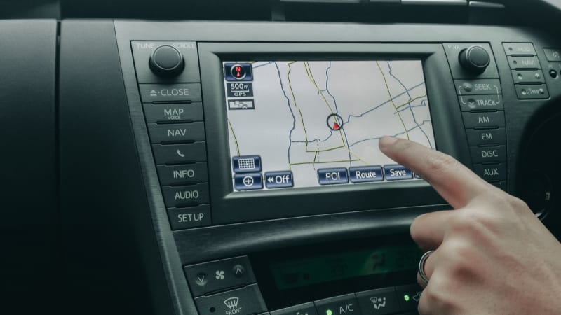 human hand control and point to car moniyor display with GPS navigator with interior design in luxury car