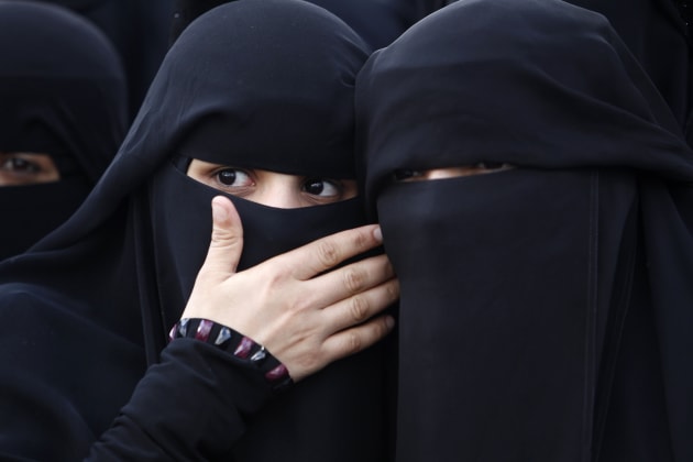 Two women wearing niqabs.