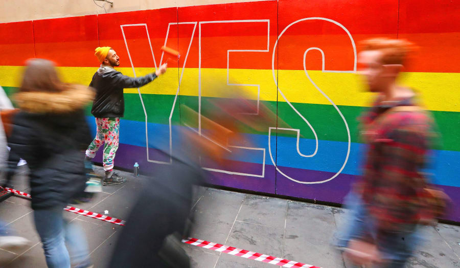 Melbourne, Australia -- August 27: Artist David Lee Pereira paints a marriage equality mural on a wall.