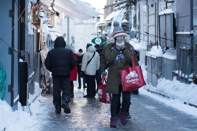 People walk down an icy street in Quebec City on Wednesday.