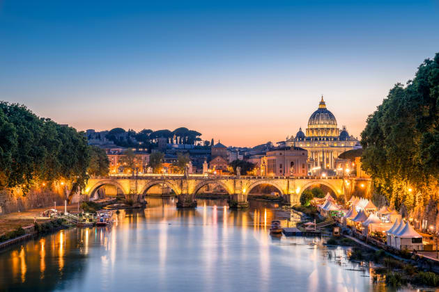 view of Tiber River and Ponte Sant Angelo Bridge Saint Peter's Basilica (Vaticane) at sunset time, Rome,