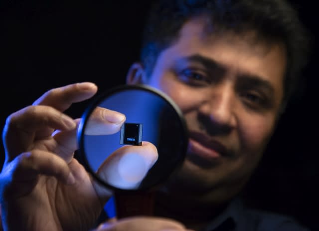 Intel Fellow Wilfred Gomes, a member of Intel's Silicon Engineering Group, holds a processor with the advanced packaging technology called Foveros. It combines unique three-dimensional stacking with a hybrid computing architecture that mixes and matches multiple types of cores for different functions. 