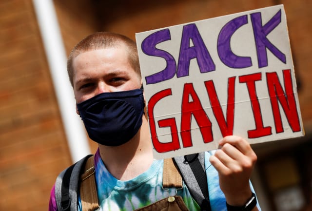 A-level student holds a placard during a protest about the exam results at the constituency offices of Education Secretary Gavin Williamson, amid the spread of the coronavirus disease (COVID-19), in South Staffordshire, Britain, August 17, 2020. REUTERS/Jason Cairnduff