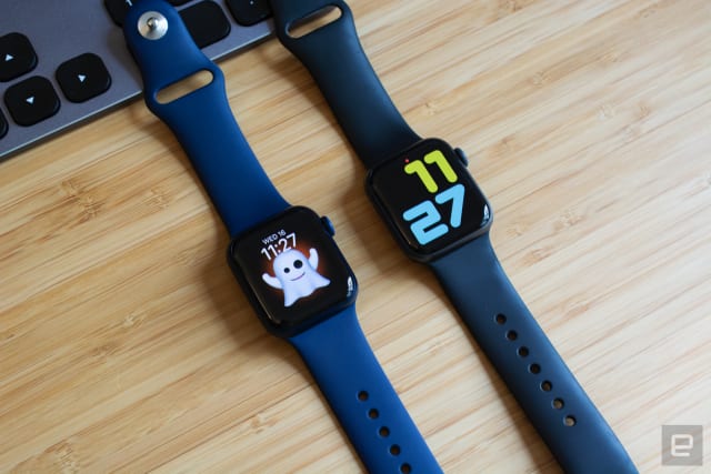 The Apple Watch Series 6 (left) next to the Apple Watch Series 5 (right) on a wooden table.