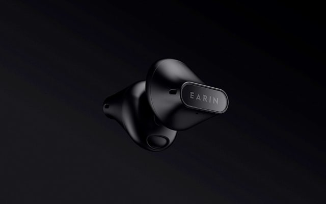 Earin A-3 earbuds in black on a black background.