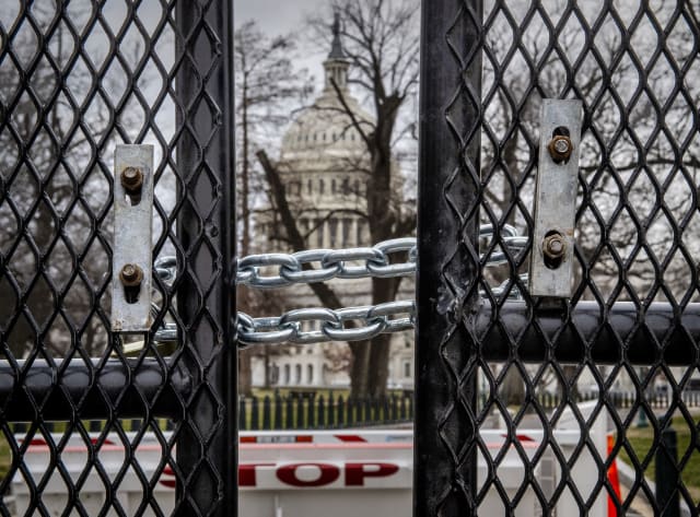 WASHINGTON, DC - January 08:  The U.S. Capitol is visible through a gap in the tall new fencing erected in the wake of the looting on Wednesday, in Washington, DC on January 08.  (Photo by Bill O'Leary/The Washington Post via Getty Images)
