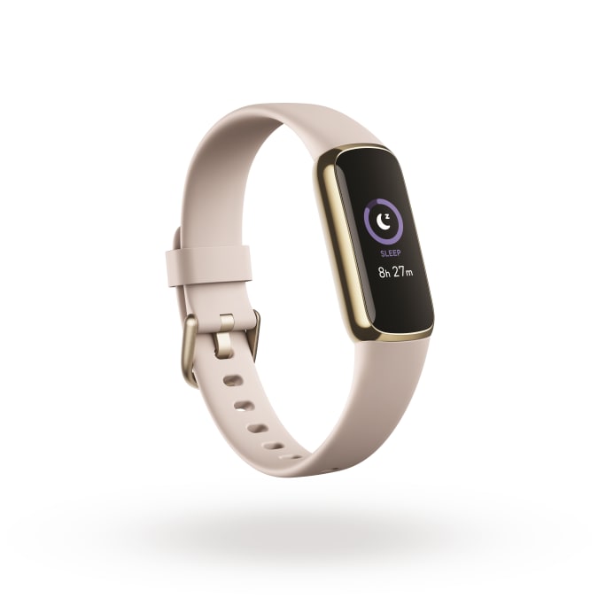Product render of Fitbit Luxe, 3QTR view, in Lunar White and Soft Gold.