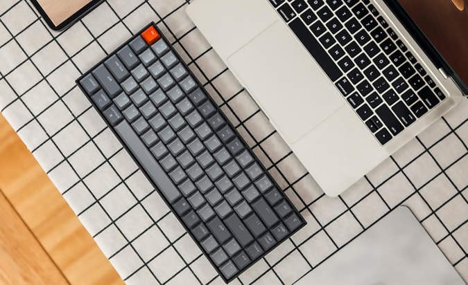 An overhead shot of the Keychron K2 and a laptop.