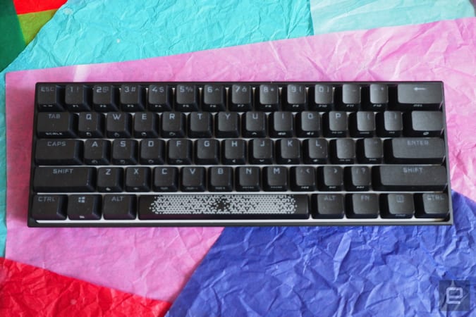 Corsair K65 RGB Mini in black on a bed of colored paper