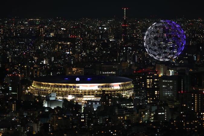 Tokyo 2020 Olympics - The Tokyo 2020 Olympics Opening Ceremony - Olympic Stadium, Tokyo, Japan - July 23, 2021. Drones form a shape of the world during the opening ceremony, seen above the Olympic Stadium REUTERS/Kim Kyung-Hoon