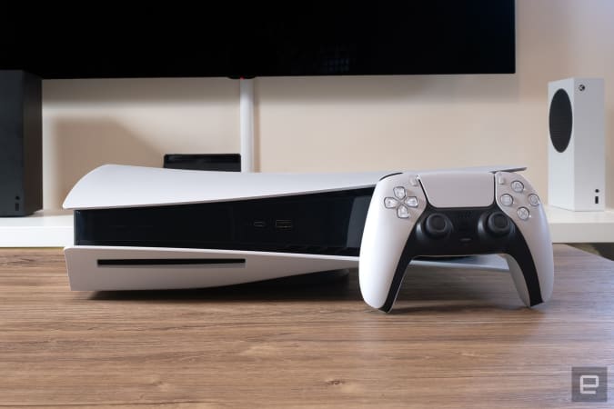 Sony PlayStation 5 with Xbox consoles in background