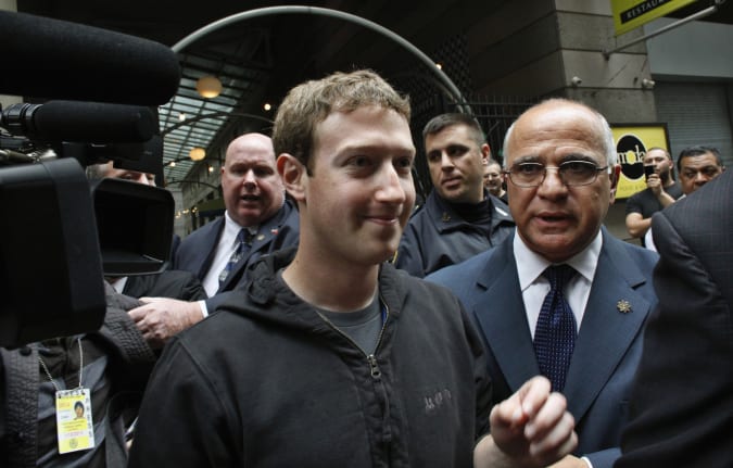 Facebook Inc. CEO Mark Zuckerberg is escorted by security guards as he departs New York City's Sheraton Hotel May 7, 2012. Facebook Inc kicked off its IPO roadshow in New York on Monday, attracting hundreds of investors to the Sheraton as the world's largest social network aims to raise about $10.6 billion, dwarfing the coming-out parties of tech companies like Google Inc and granting it a market value close to Amazon.com Inc's.   REUTERS/Eduardo Munoz    (UNITED STATES - Tags: BUSINESS SCIENCE TECHNOLOGY)
