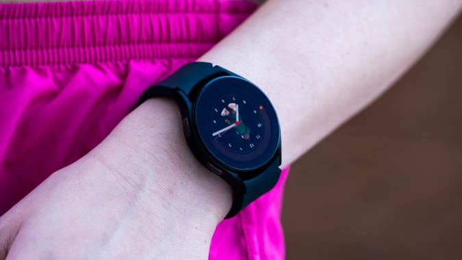 A black Samsung Galaxy Watch 4 on the wrist