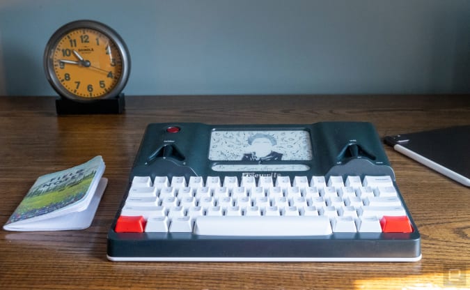A standalone word processor with a freewrite keyboard sits on the desktop.