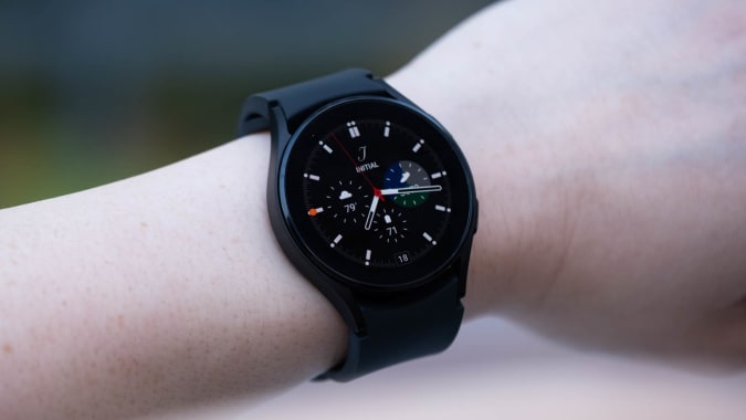 A black Samsung Galaxy Watch 4 on a wrist: