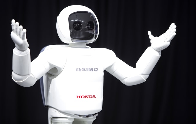 Honda Motor's Asimo robot puts on a demonstration for the media at the Jacob Javits Convention Center during the New York International Auto Show in New York April 17, 2014.  REUTERS/Carlo Allegri (UNITED STATES - Tags: TRANSPORT BUSINESS)
