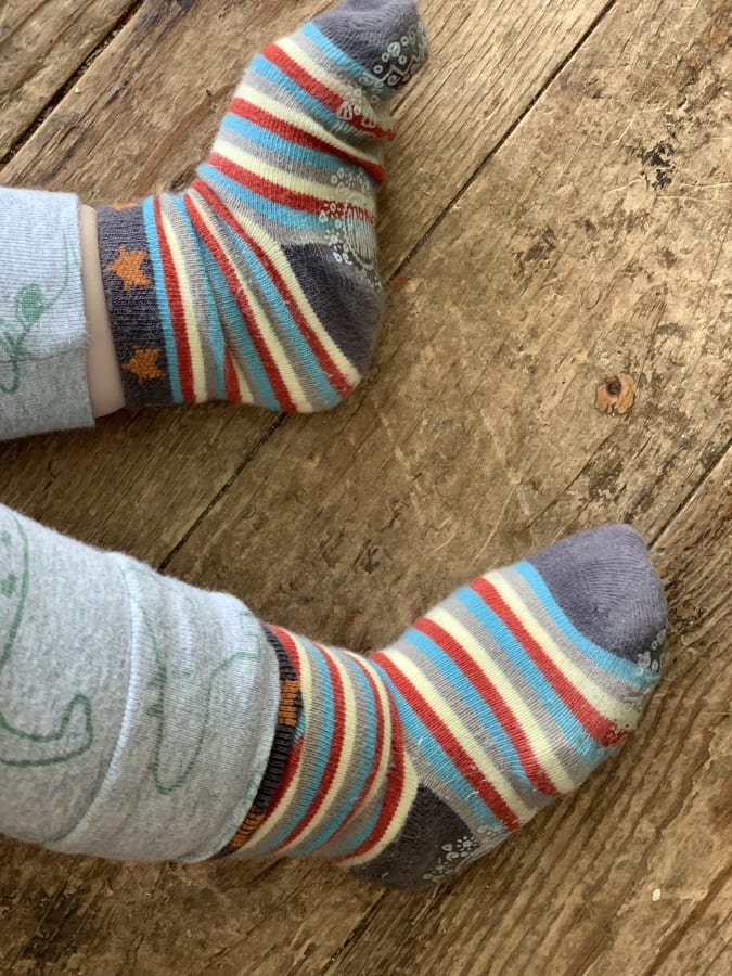 Owlet Smart Sock Plus worn underneath a fabric sock
