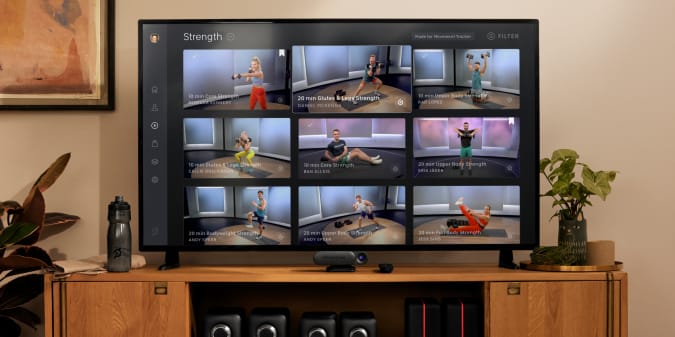 A TV displaying a selection of Peloton Guide's strength training classes.