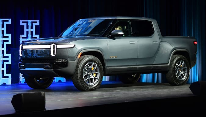 The Rivian R1T arrives on stage as the 2022 Truck of the Year finalist at the LA Auto Show in Los Angeles, Calif. On November 17, 2021. (Photo by Frederic J. BROWN / AFP) (Photo by FREDERIC J. BROWN / AFP via Getty Images)