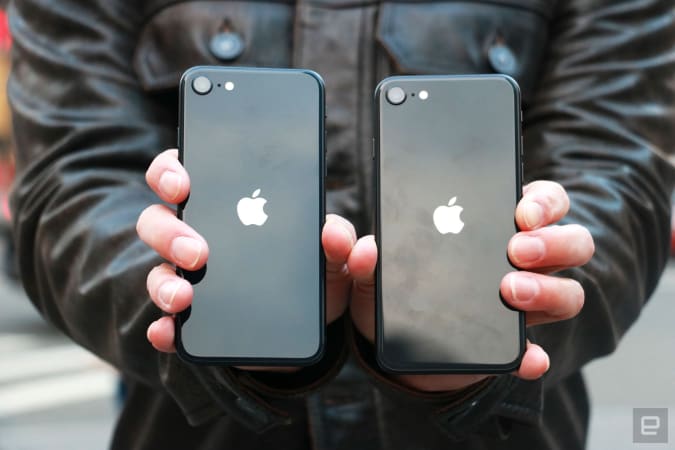 The iPhone SE (2022) and the iPhone SE (2020) held up side by side with their backs facing the camera.