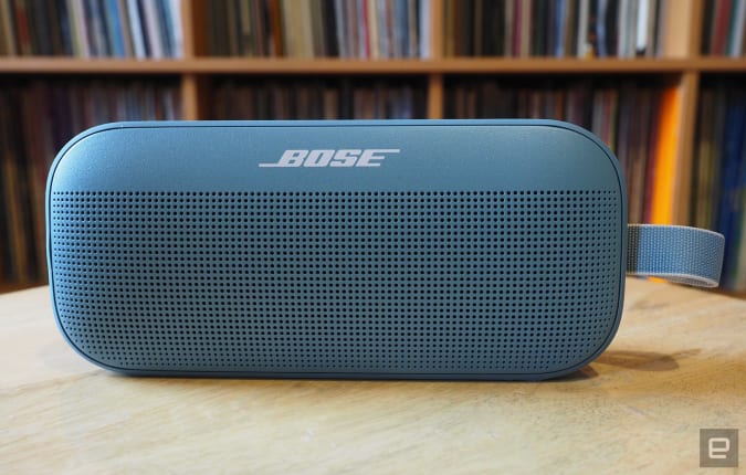 The Bose Soundlink Flex photographed for Engadget's 2022 portable Bluetooth speaker guide in front of a shelf full of records.