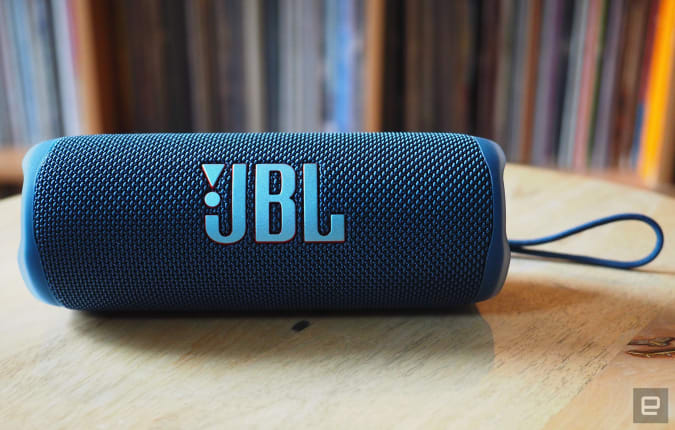 The JBL Flip 6 photographed for Engadget's 2022 portable Bluetooth speaker guide in front of a shelf full of records.