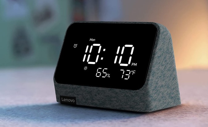 The Lenovo Smart Clock Essential on a gray table.