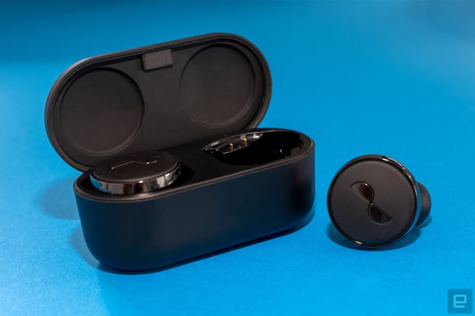 A NuraTrue earbud is pictured next to the charging case.