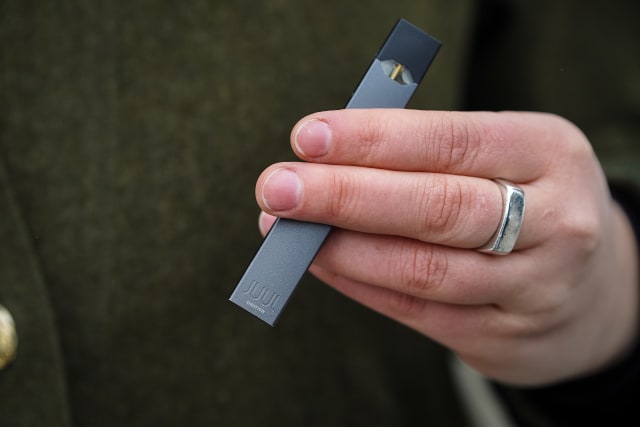 A woman is holding a Juul e-cigarette, in Montreal.
