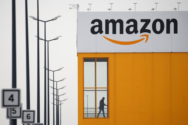 The logo of Amazon is seen at the company logistics center in Lauwin-Planque, northern France, March 19, 2020. Several hundred employees protested in France, calling on the U.S. e-commerce giant to halt operations or make it easier for employees to stay away during the coronavirus (COVID-19) epidemic. REUTERS/Pascal Rossignol