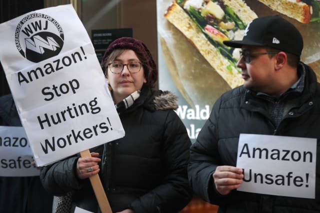 CHICAGO, ILLINOIS - DECEMBER 10: Former injured Amazon employees join labor organizers and community activists to demonstrate and hold a press conference outside of an Amazon Go store in the loop to express concerns about what they claim is the company's "alarming injury rate" among warehouse workers on December 10, 2019 in Chicago, Illinois. According to the community group Warehouse Workers for Justice, some Amazon warehouse facilities have injury rates more than twice the industry average, with peak rates occurring during the holiday season. (Photo by Scott Olson/Getty Images)