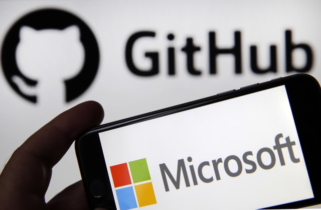 PARIS, FRANCE - JUNE 04: In this photo illustration the Microsoft logo is seen on the screen of an iPhone in front of a computer screen showing a GitHub logo on June 04, 2018 in Paris, France. The American computer and micro-computing company Microsoft announced Monday the acquisition of the platform for computer developers GitHub for 7.5 billion dollars. Created in 2008, GitHub has become an essential tool for IT developers around the world. (Photo Illustration by Chesnot/Getty Images)