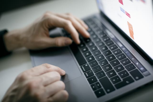 BERLIN, GERMANY - FEBRUARY 04: Symbol photo. A man is typing with his hands on a keyboard of a MacBook Pro on February 04, 2020 in Berlin, Germany. (Photo by Felix Zahn/Photothek via Getty Images)