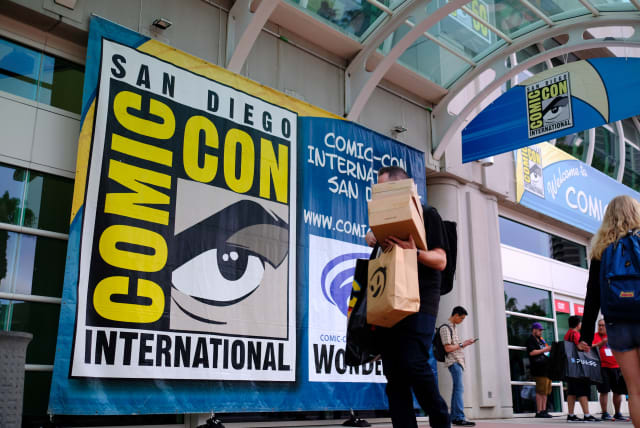 People walk in front of the Convention Center during Comic Con in San Diego, California on July 17, 2019. (Photo by Chris Delmas / AFP) (Photo credit should read CHRIS DELMAS/AFP via Getty Images)
