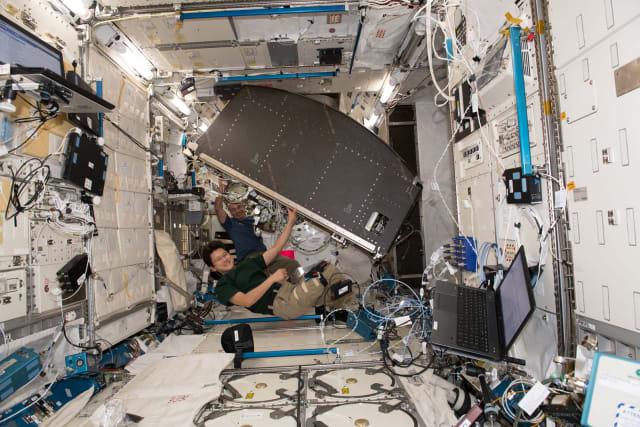 Astronauts move NASA's EXPRESS Rack 4 on the ISS