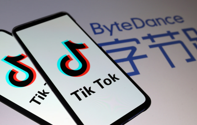 Tik Tok logos are seen on smartphones in front of a displayed ByteDance logo in this illustration taken November 27, 2019. REUTERS/Dado Ruvic/Illustration