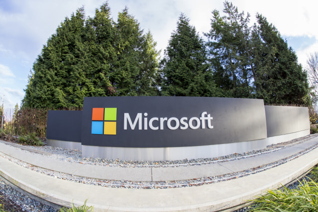 Redmond, WA, USA - January 30, 2018: One of the biggest Microsoft signs is placed next to green trees at a public intersection near Microsoft's Redmond campus