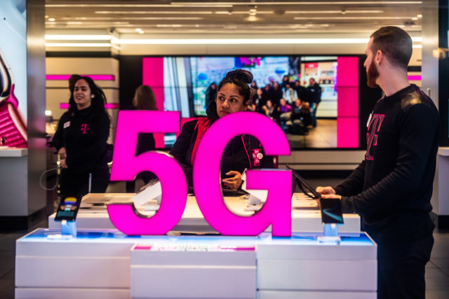 NEW YORK CITY, UNITED STATES - 2020/02/20: Customers at a T-Mobile store, with 5G signage. (Photo Illustration by Alex Tai/SOPA Images/LightRocket via Getty Images)