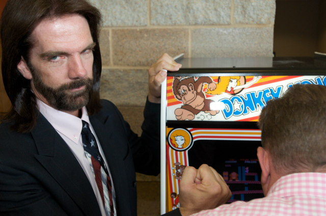 OTTUMWA, IA - AUGUST 13: Billy Mitchell, the Video Game Player of the Century, poses while Steve Sanders, 'The Orignal King of Kong,' plays Donkey Kong at the launch party for the International Video Game Hall of Fame and Museum on August 13, 2009 in Ottumwa, Iowa. Ottumwa was officially proclaimed the Video Game Capital of the World at the launch party and plans are underway to build a full museum in the small Iowa city. The rivelry of Sanders and Mitchell is documented in the movie 'The King of Kong' where they played each other for the best score ever. (Photo by David Greedy/Getty Images)