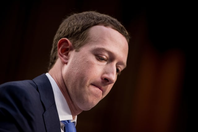 TOPSHOT - Facebook CEO Mark Zuckerberg listens during a joint hearing of the Senate Commerce, Science and Transportation Committee and Senate Judiciary Committee on Capitol Hill April 10, 2018 in Washington, DC.
Facebook chief Mark Zuckerberg took personal responsibility Tuesday for the leak of data on tens of millions of its users, while warning of an "arms race" against Russian disinformation during a high stakes face-to-face with US lawmakers. / AFP PHOTO / Brendan Smialowski (Photo credit should read BRENDAN SMIALOWSKI/AFP via Getty Images)