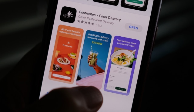 This illustration photo taken on June 30, 2020 shows the logo of delivery app Postmates on a smartphone screen in Los Angeles. - Uber is in talks to buy food delivery app Postmates in a multibillion dollar deal, US media reported. (Photo by Chris DELMAS / AFP) (Photo by CHRIS DELMAS/AFP via Getty Images)